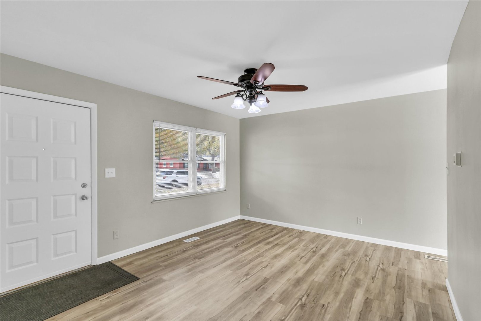 2808 Carrelton Drive Champaign, IL 61821 - Photo 5 of 24 wooden floor in an empty room with a window