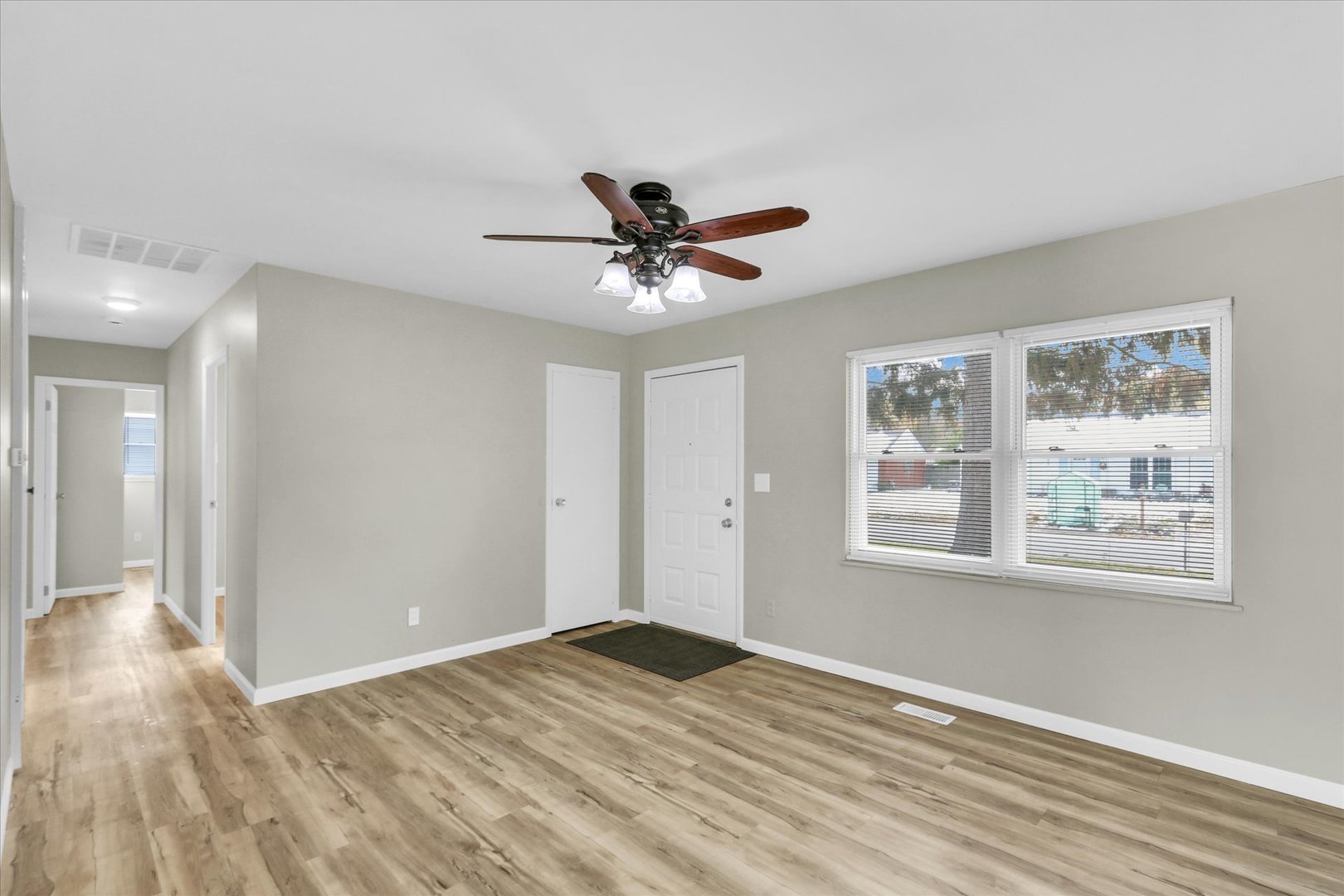2808 Carrelton Drive Champaign, IL 61821 - Photo 6 of 24 a view of empty room with wooden floor and fan