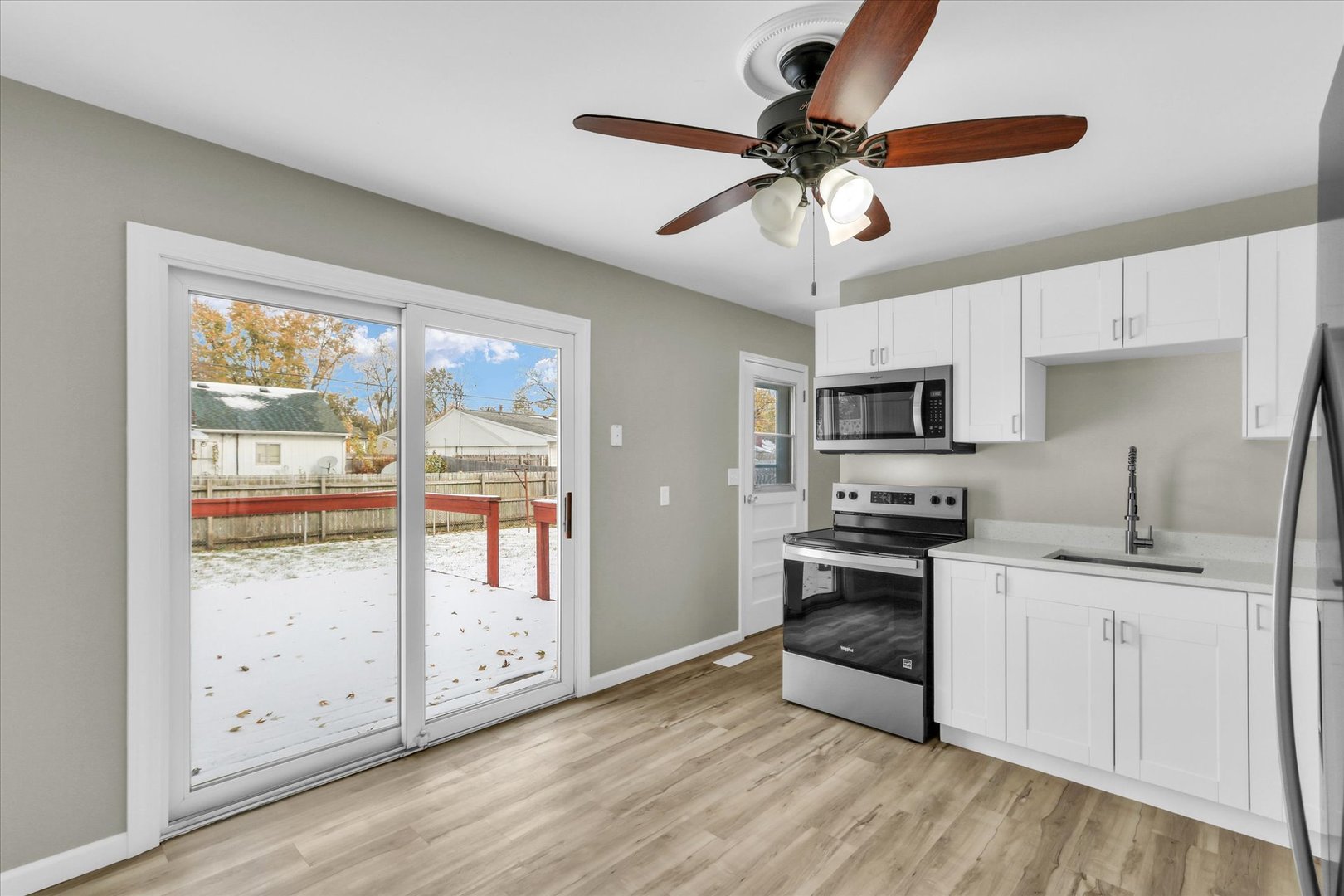 2808 Carrelton Drive Champaign, IL 61821 - Photo 8 of 24 a kitchen with stainless steel appliances granite countertop a stove top oven a sink a refrigerator with white cabinets and wooden floor