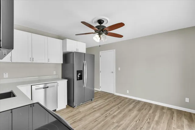 a view of a kitchen with a sink and cabinets