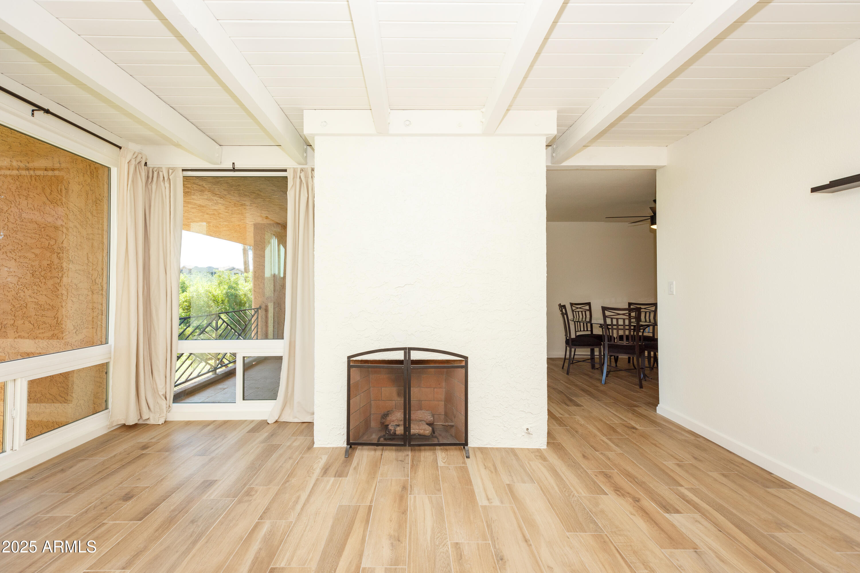 an empty room with wooden floor and a window