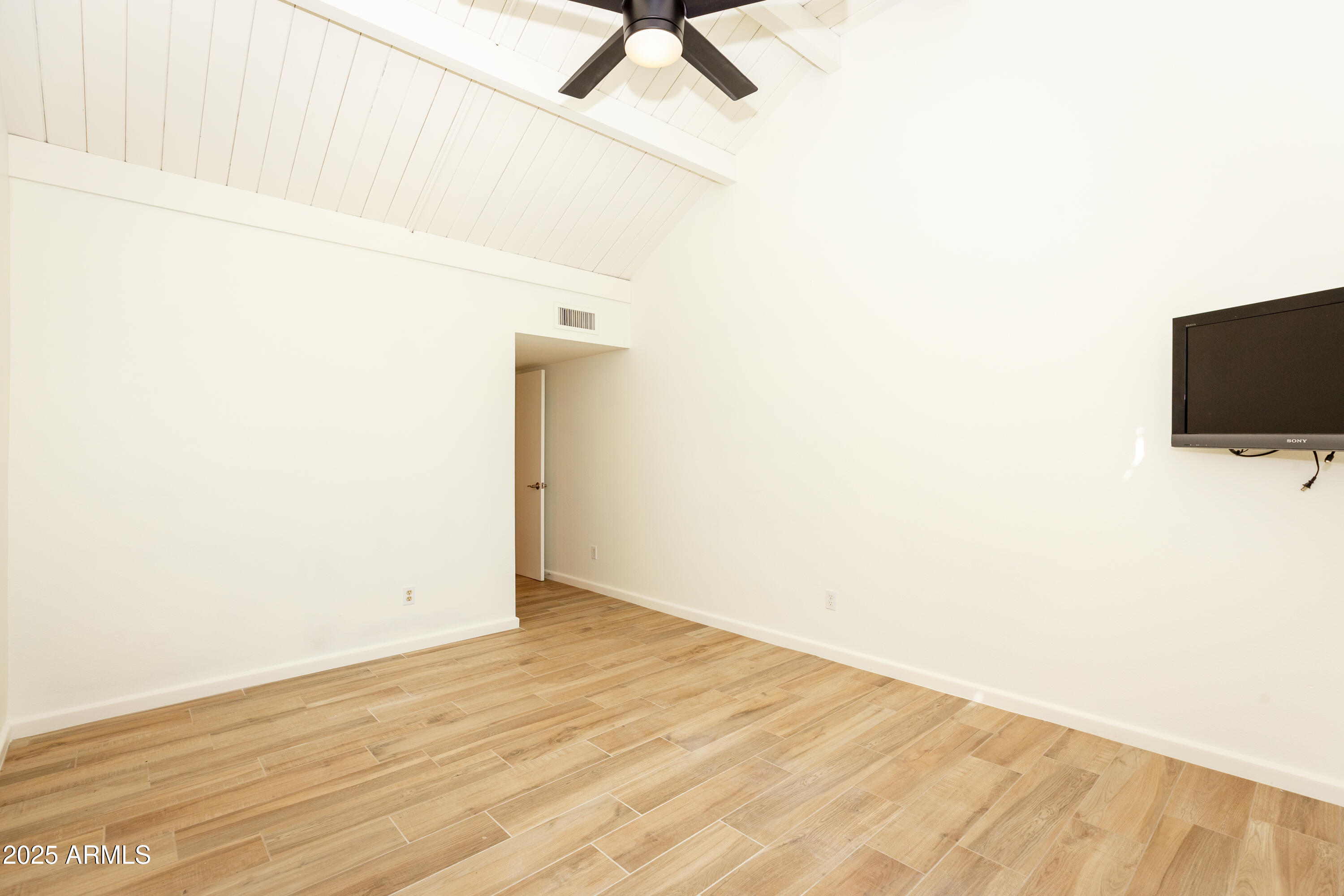 7401 North Scottsdale Road, Unit 51 Paradise Valley, AZ 85253 - Photo 11 of 12 a view of room with wooden floor and ceiling fan