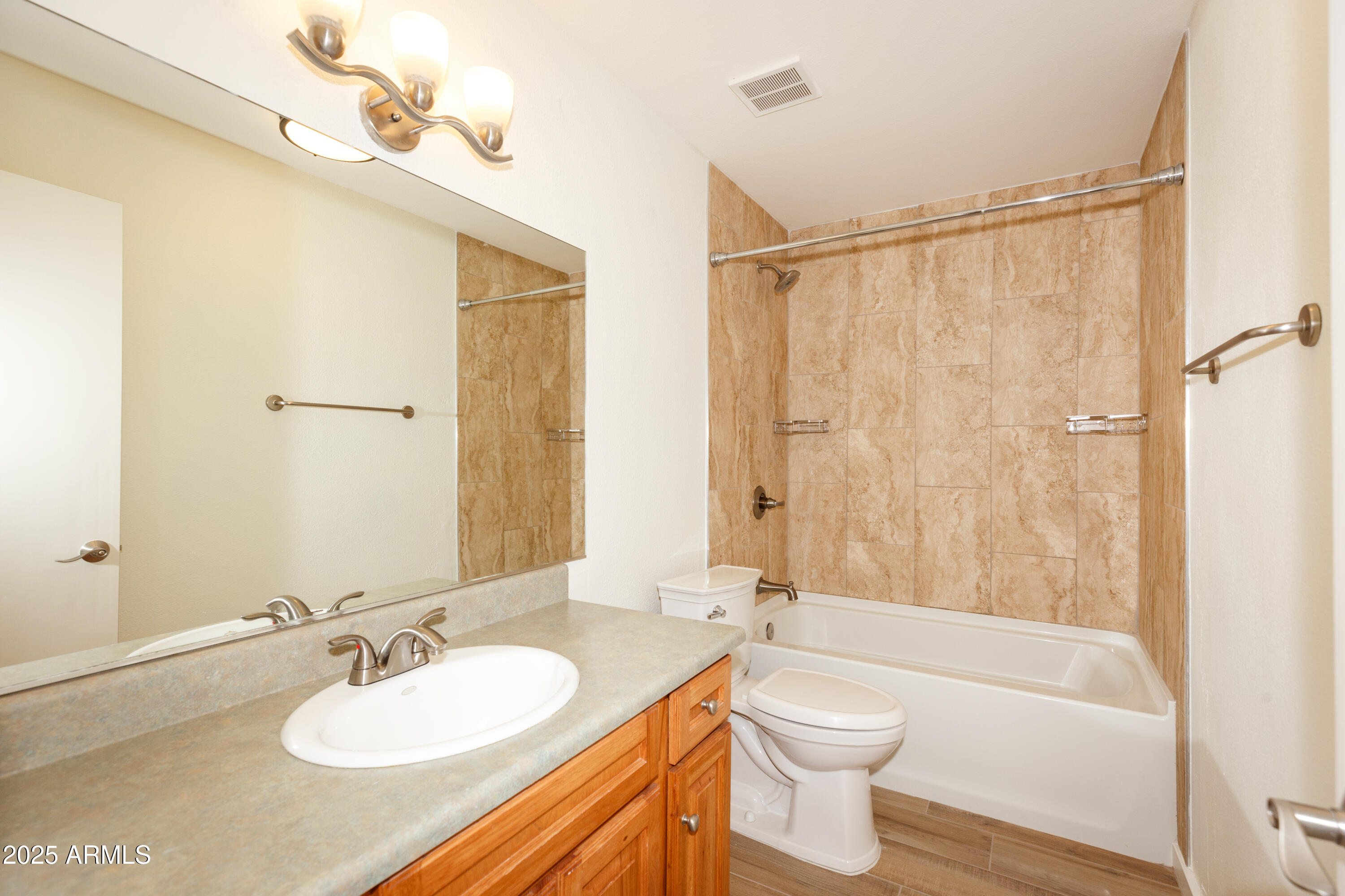 7401 North Scottsdale Road, Unit 51 Paradise Valley, AZ 85253 - Photo 7 of 12 a bathroom with a granite countertop sink toilet a mirror and shower