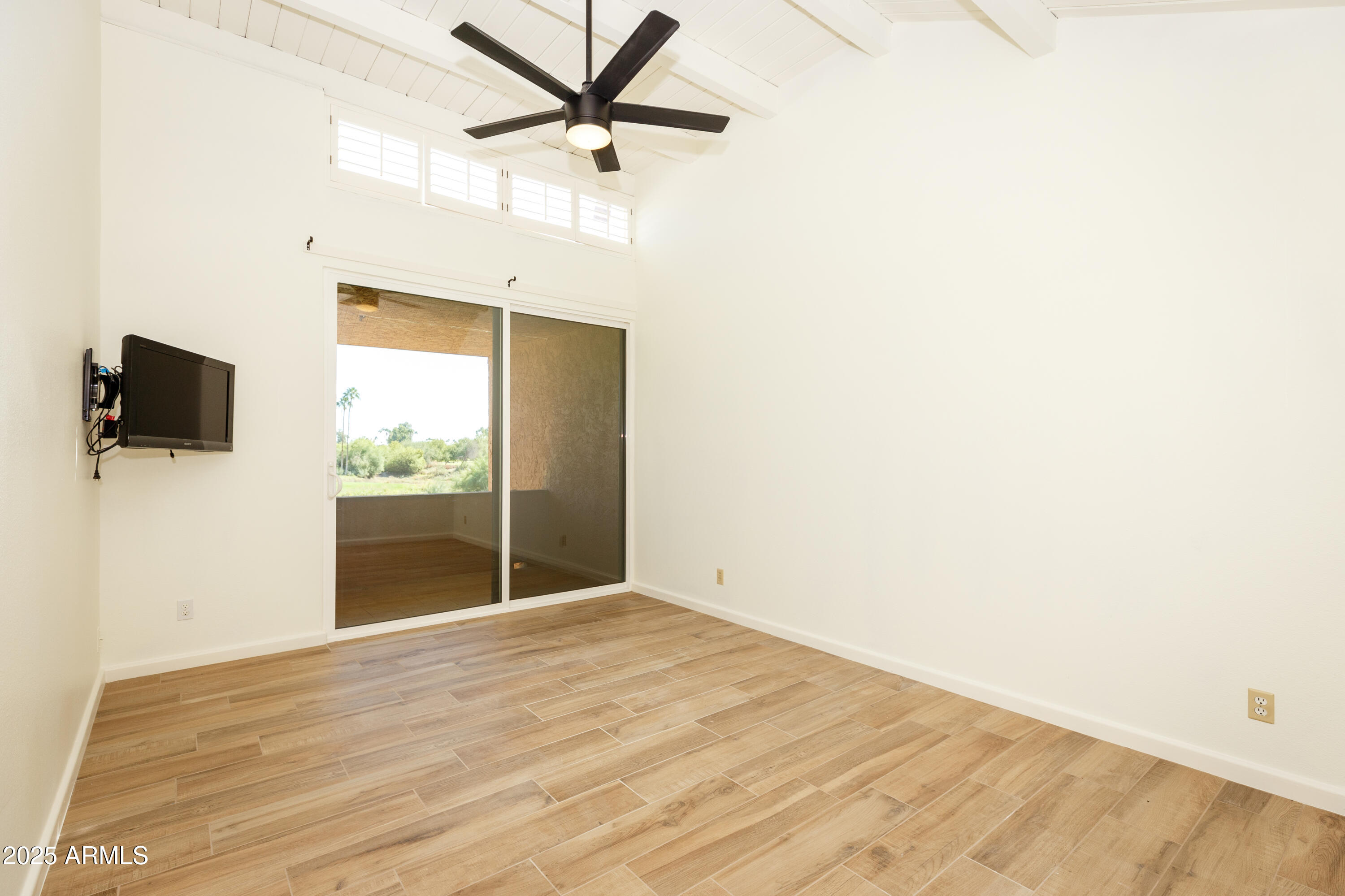 7401 North Scottsdale Road, Unit 51 Paradise Valley, AZ 85253 - Photo 10 of 12 a view of a livingroom with wooden floor and a flat screen tv