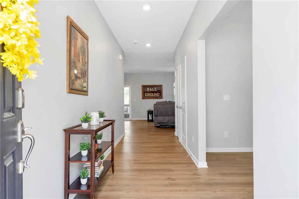 660 Groover Street Ball Ground, GA 30107 - Photo 4 of 53 a hallway with wooden floor and furniture