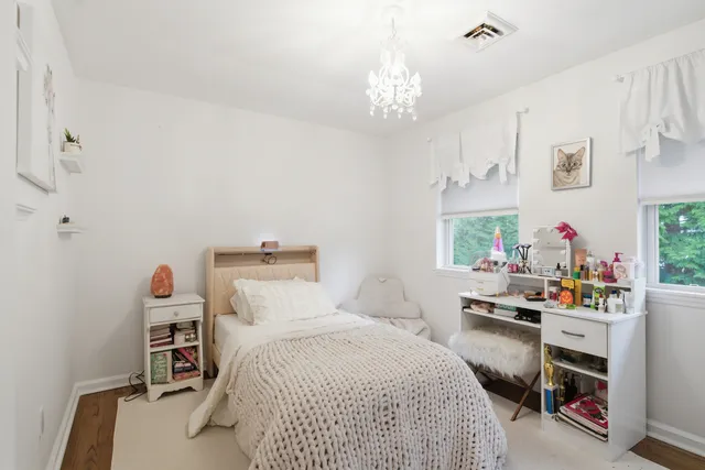 a bedroom with a bed and a desk in it