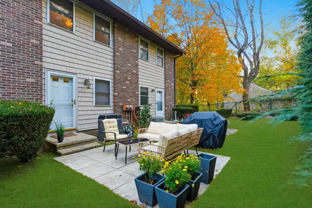 a view of a house with backyard sitting area and garden