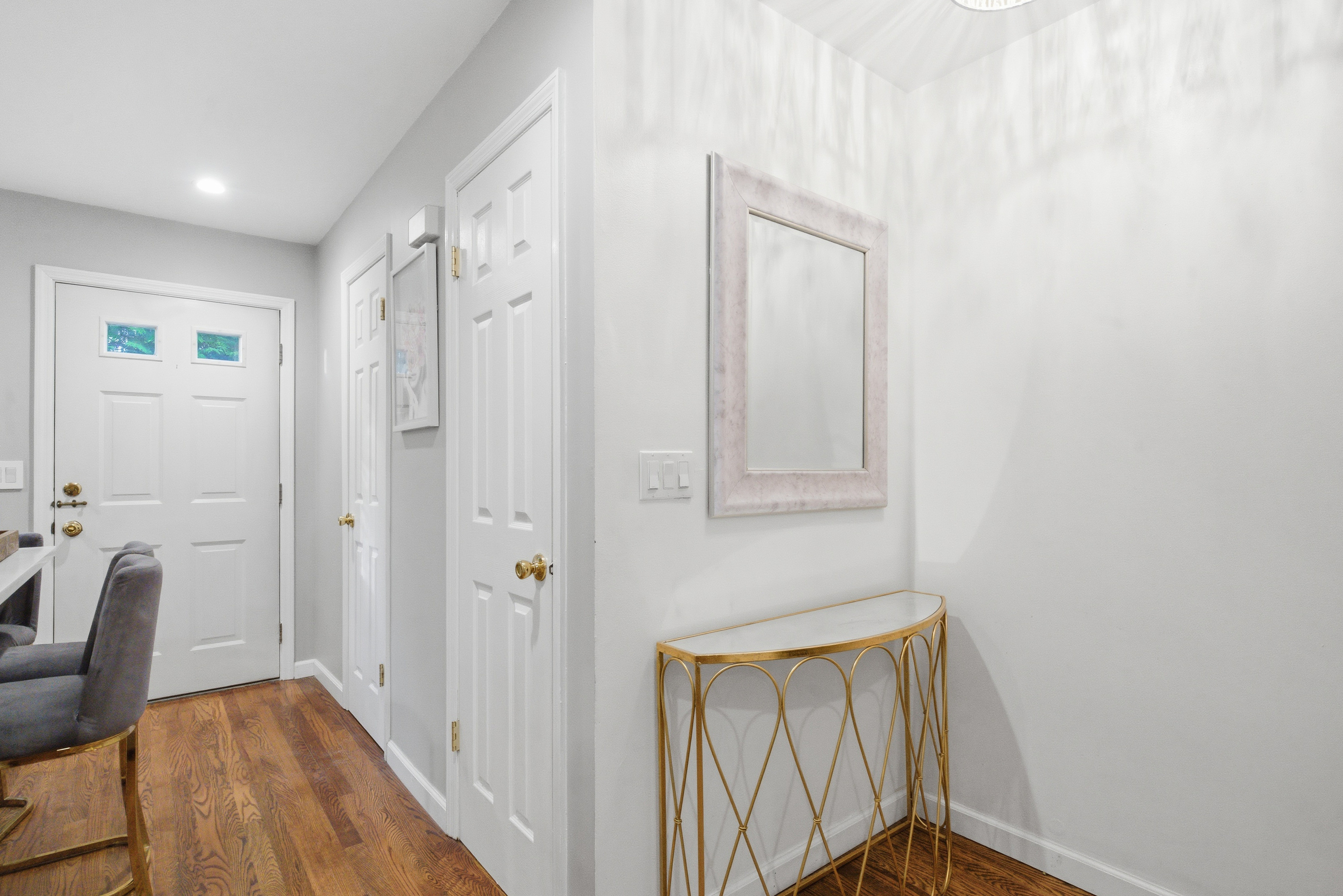 382 Knapps Highway, Unit 382 Fairfield, CT 06825 - Photo 4 of 22 a view of a hallway with wooden floor and staircase