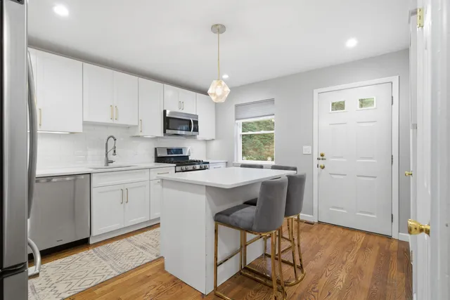 a kitchen with a sink a window and stainless steel appliances