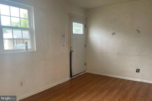 108 Price Road Chester, MD 21619 - Photo 7 of 10 an empty room with wooden floor and windows