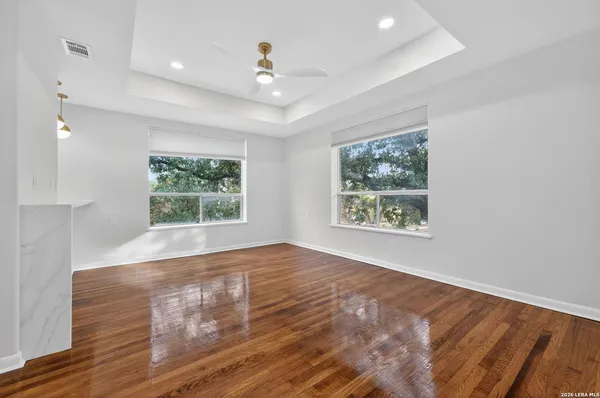 a front view of a house with garden and trees