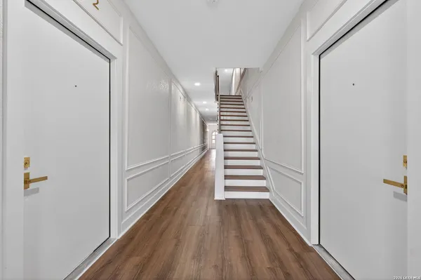 a kitchen with kitchen island granite countertop a refrigerator and a sink