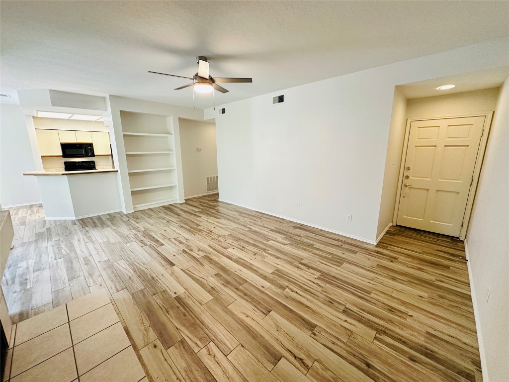 4711 Spicewood Springs Road, Unit 3118 Austin, TX 78759 - Photo 2 of 25 a view of empty room with wooden floor and fan