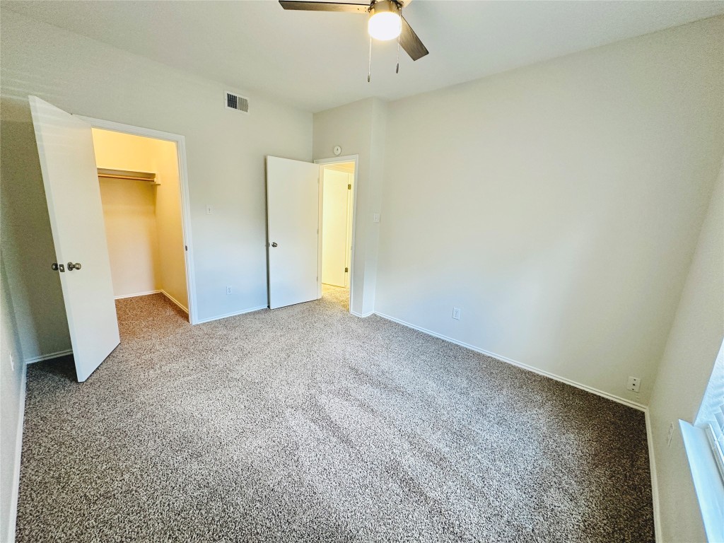 4711 Spicewood Springs Road, Unit 3118 Austin, TX 78759 - Photo 22 of 25 an empty room with a ceiling fan
