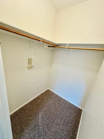 an empty room with a ceiling fan