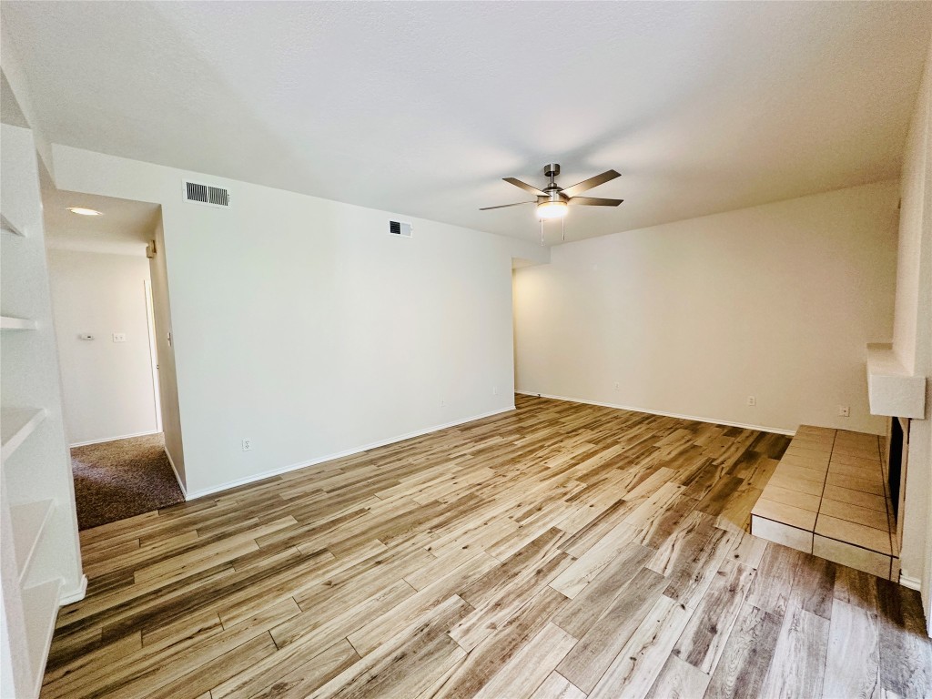 4711 Spicewood Springs Road, Unit 3118 Austin, TX 78759 - Photo 3 of 25 a view of a room with wooden floor and a ceiling fan