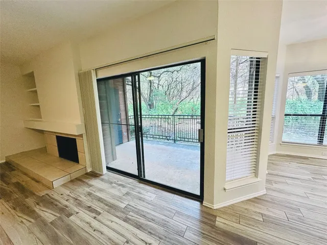 a view of a room with wooden floor and a balcony