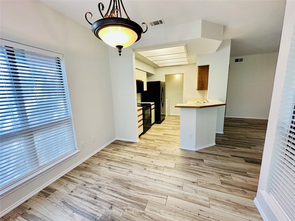4711 Spicewood Springs Road, Unit 3118 Austin, TX 78759 - Photo 6 of 25 a view of empty room with wooden floor and fan