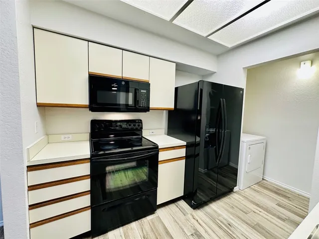 a kitchen with stainless steel appliances wooden cabinets and stove