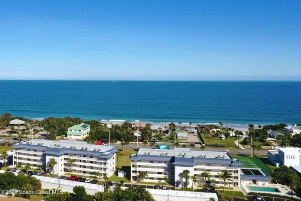 an aerial view of residential building and ocean