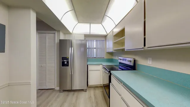 a kitchen with a refrigerator and cabinets