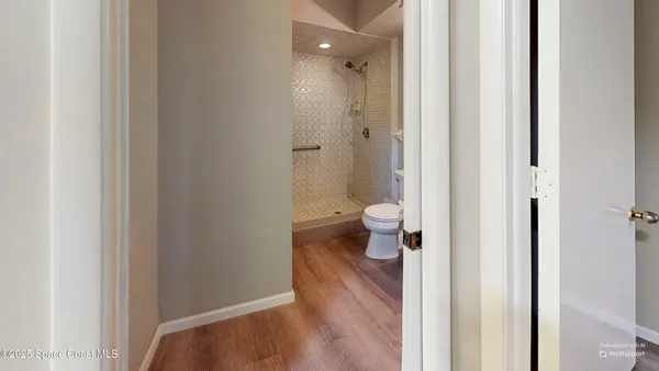 a view of a bathroom from a hallway