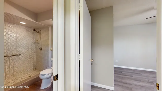 a bathroom with a toilet and a shower