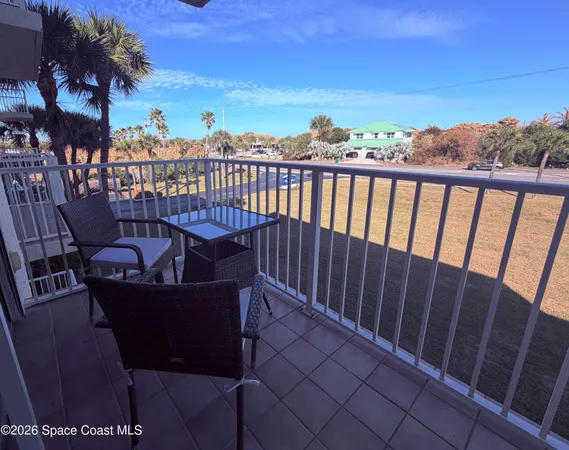 a view of a chairs and table in the balcony