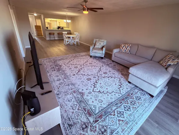 a living room with couch and a rug