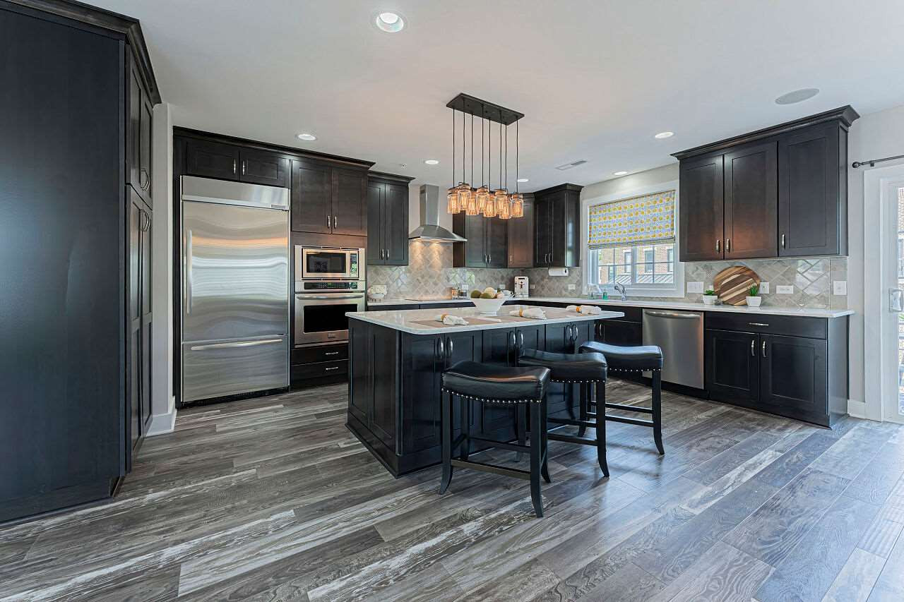 511 North Person Street, Unit 207 Raleigh, NC 27604 - Photo 6 of 17 Kitchen with custom cabinetry, SS high end appliances including built in wine cooler. Quartz countertops and surround sound. Kitchen