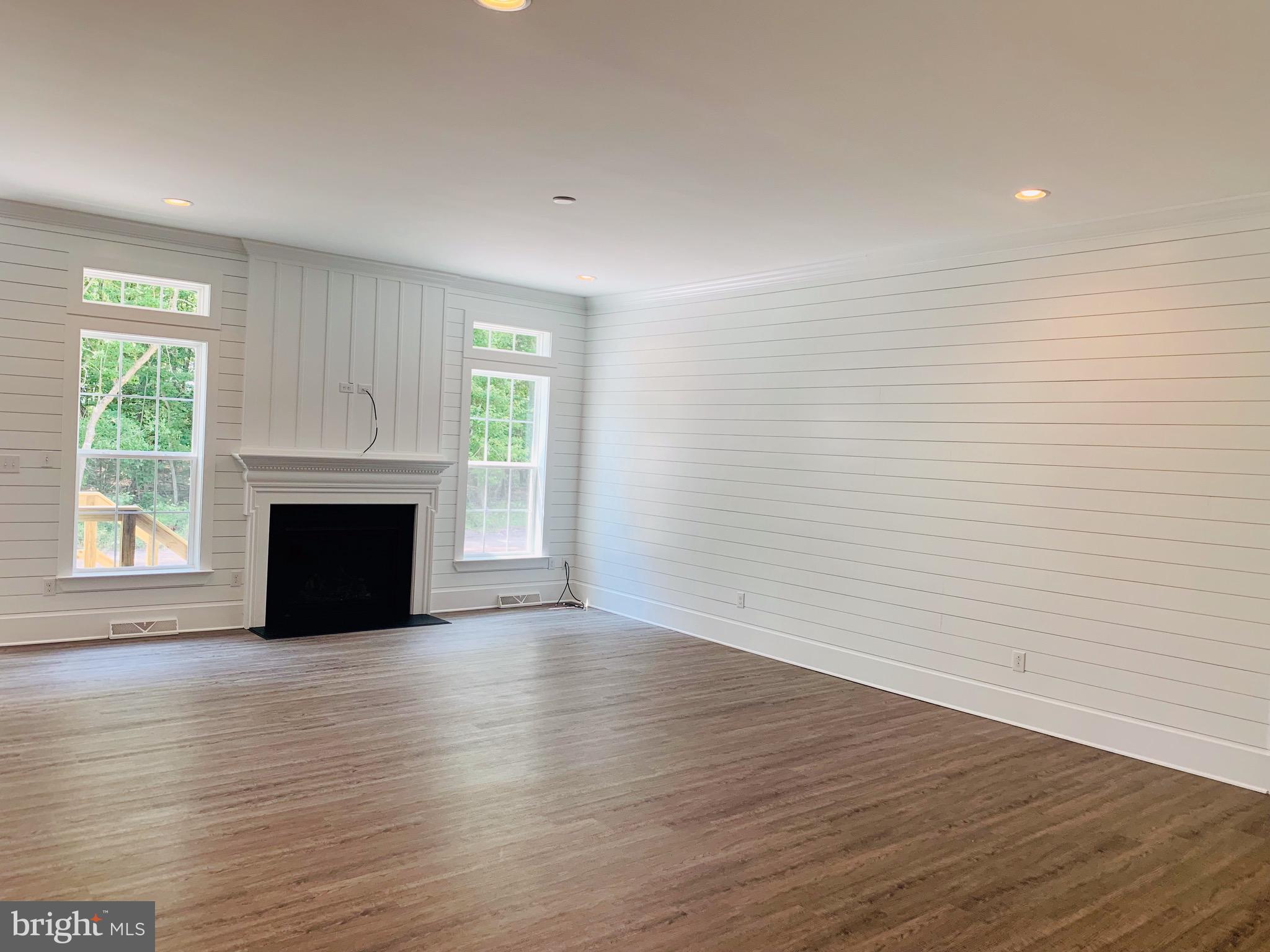 8 Patriots Way Georgetown, DE 19947 - Photo 11 of 38 a view of empty room with wooden floor and fireplace