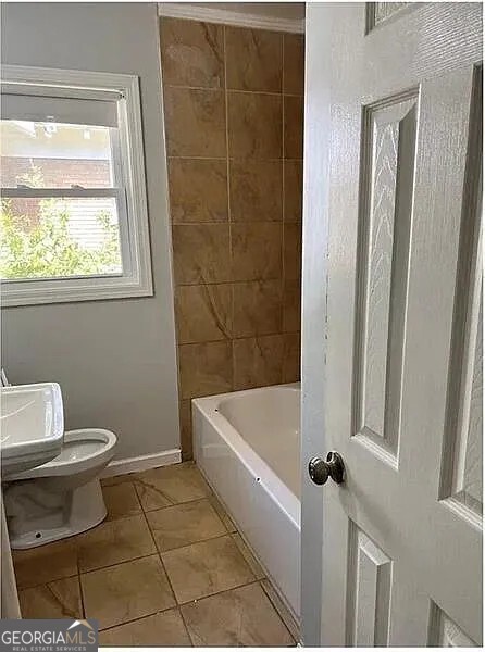2874 Cheney Street, Unit 1 East Point, GA 30344 - Photo 7 of 7 a bathroom with a toilet and a bathtub