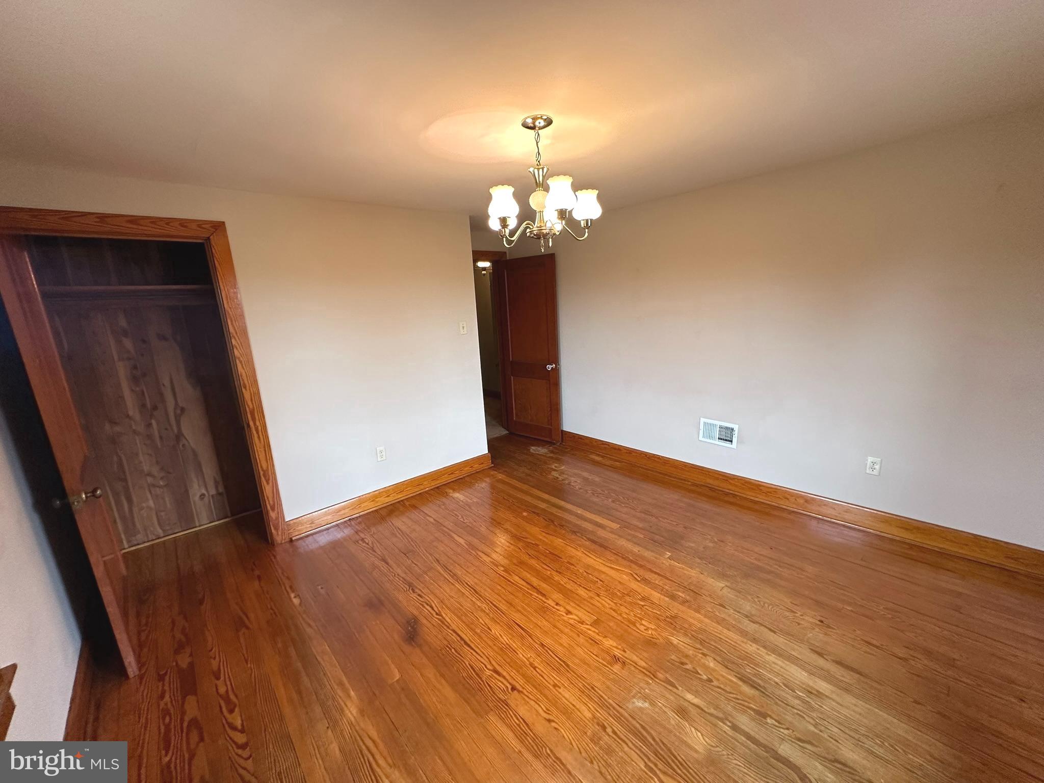 6751 York Road Spring Grove, PA 17362 - Photo 30 of 50 a view of a room with wooden floor and chandelier