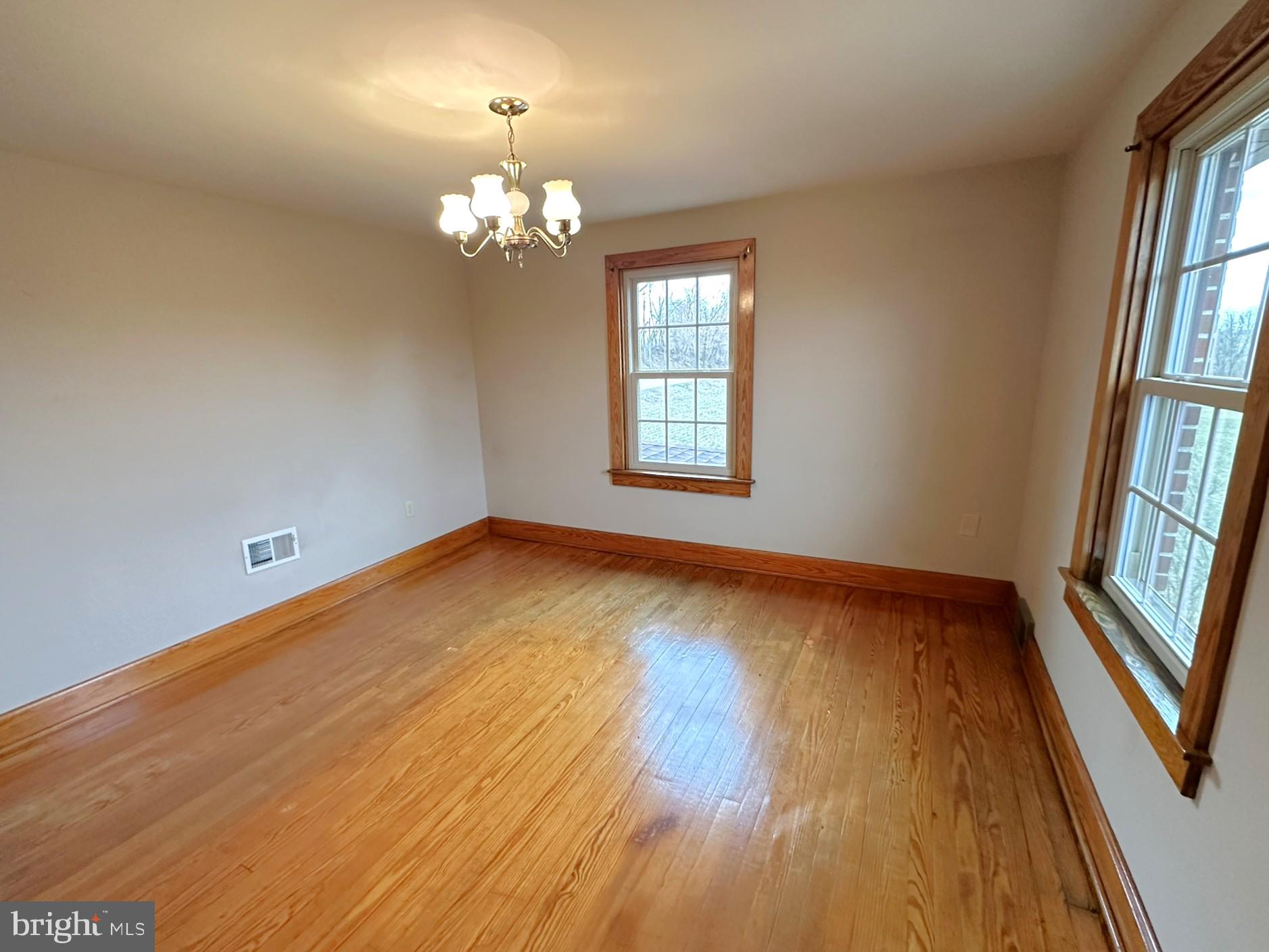 6751 York Road Spring Grove, PA 17362 - Photo 31 of 50 a view of an empty room with wooden floor and a window