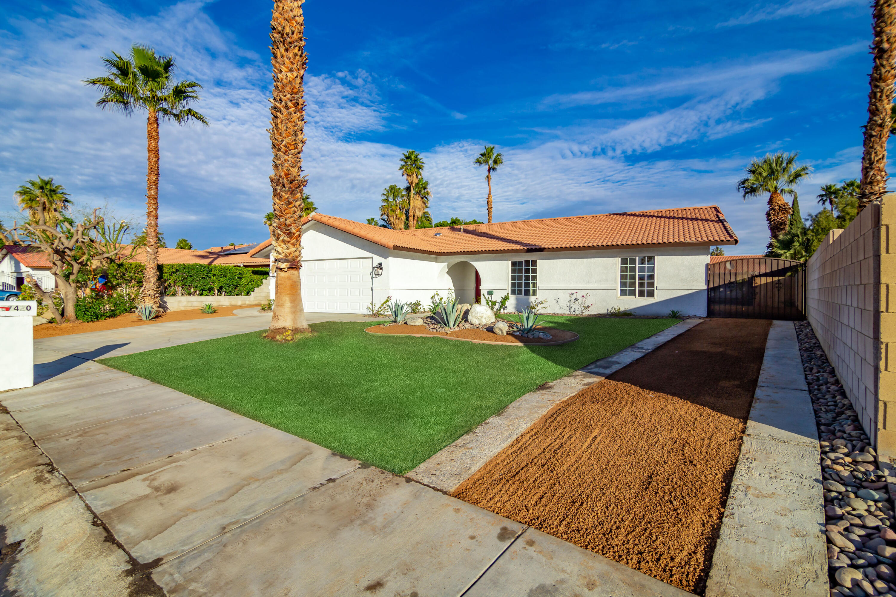 67420 Rango Road Cathedral City, CA 92234 - Photo 2 of 36 a front view of a house with a yard and garage