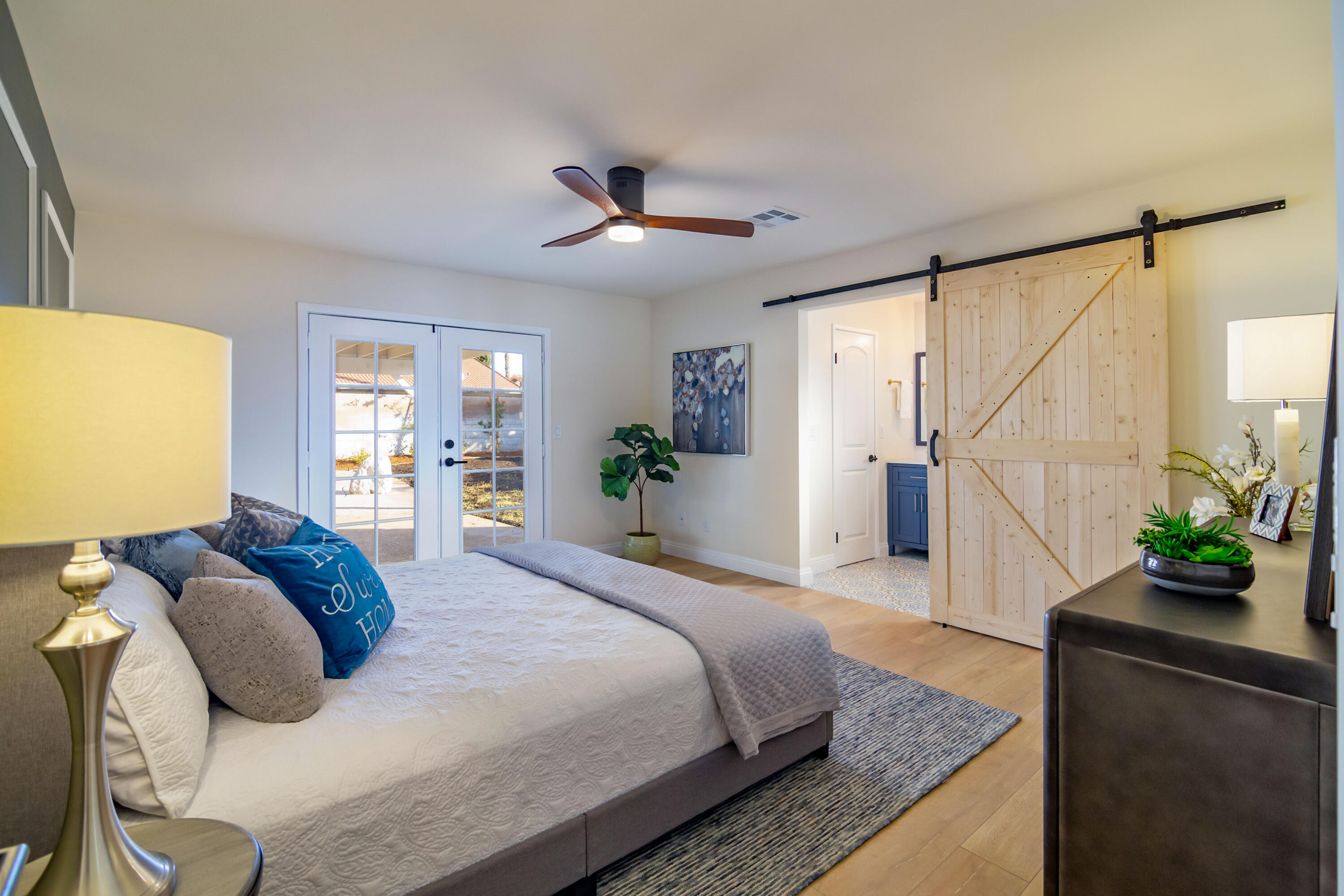 67420 Rango Road Cathedral City, CA 92234 - Photo 21 of 36 a bedroom with a large bed and a potted plant