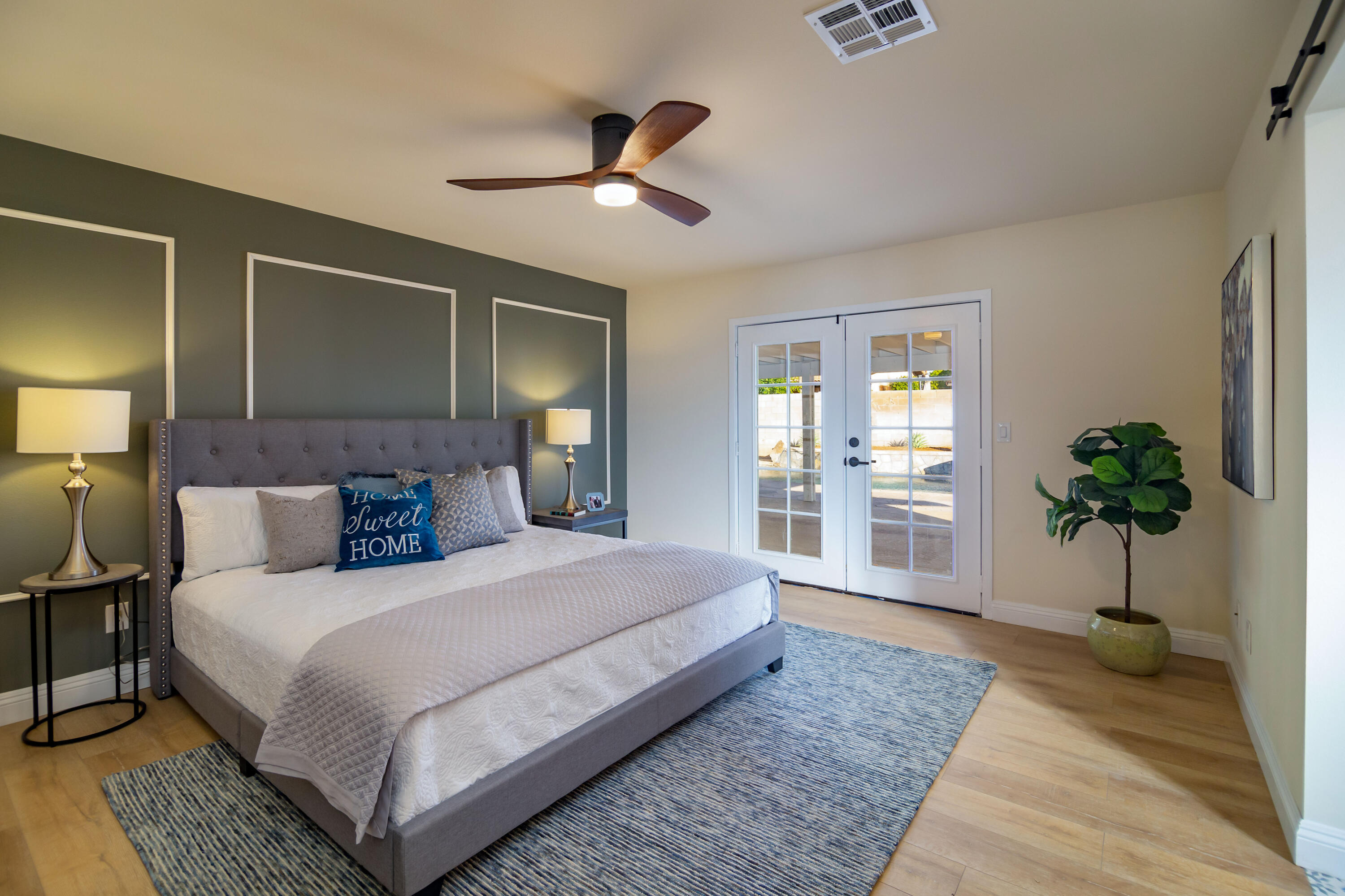67420 Rango Road Cathedral City, CA 92234 - Photo 22 of 36 a bedroom with a large bed and a potted plant