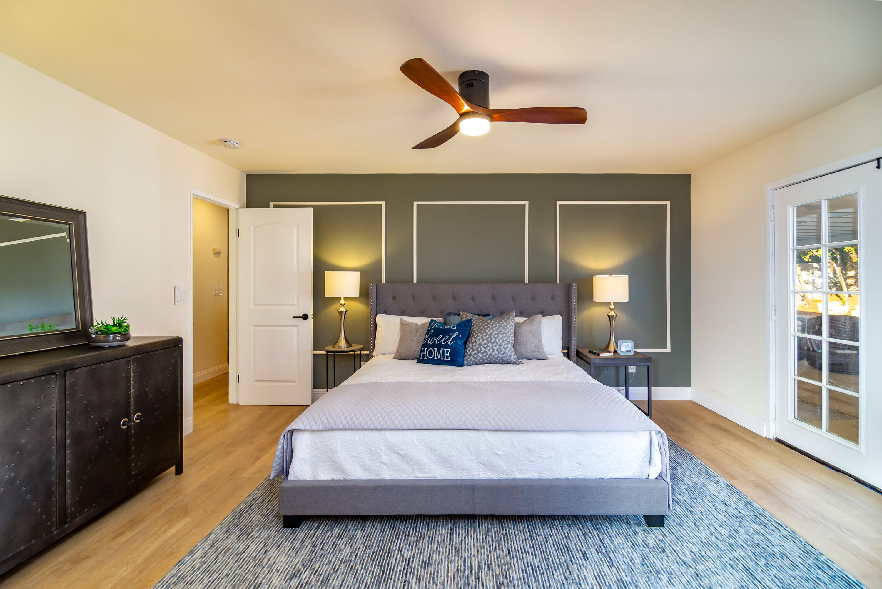 67420 Rango Road Cathedral City, CA 92234 - Photo 23 of 36 a spacious bedroom with a bed and wooden floor