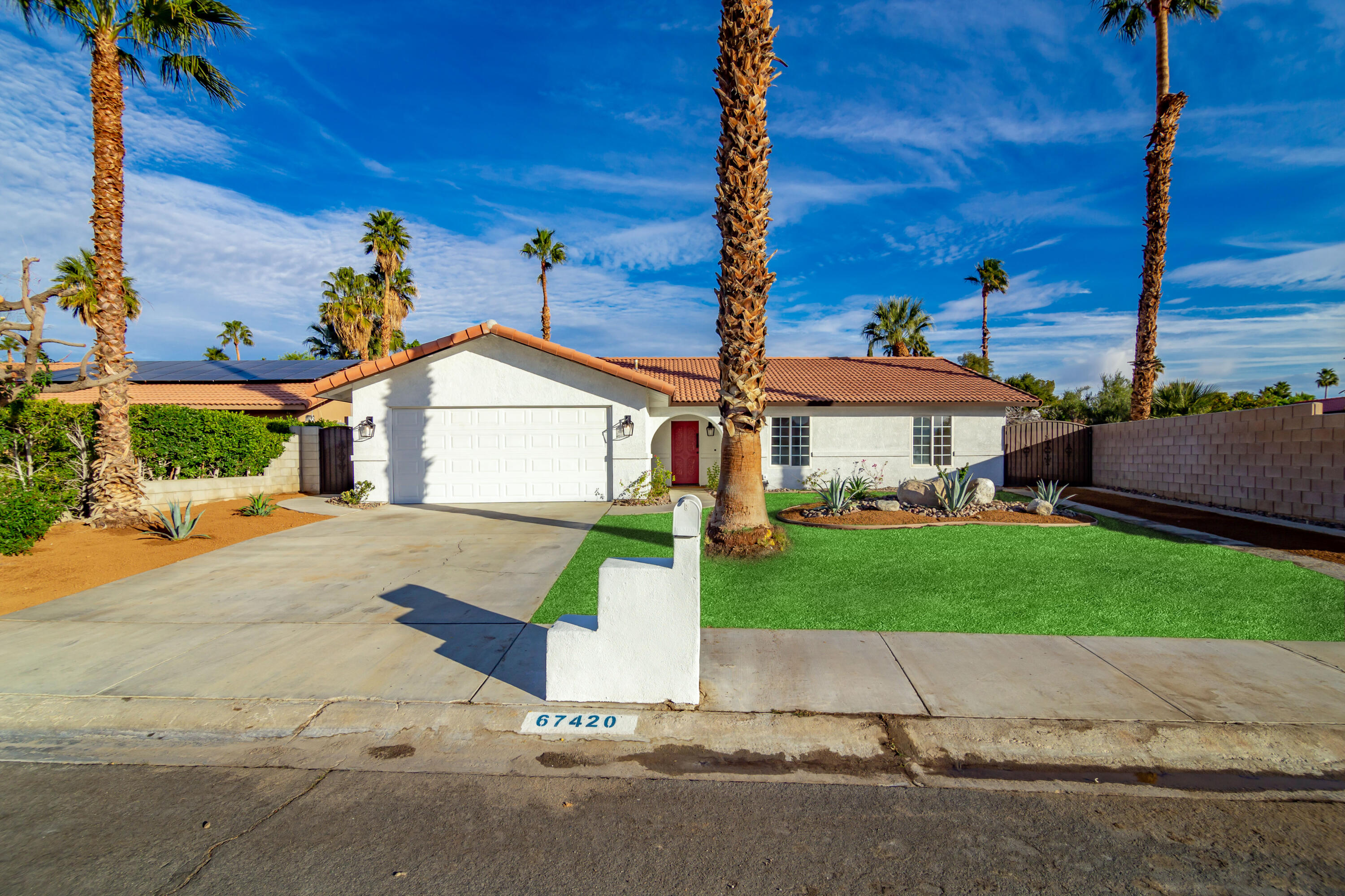 67420 Rango Road Cathedral City, CA 92234 - Photo 4 of 36 a front view of a house with a yard and garage