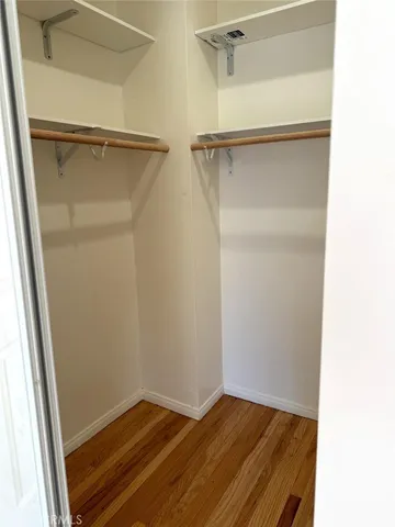 a view of closet with wooden floor