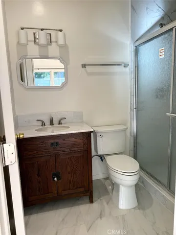 a bathroom with a sink toilet and mirror