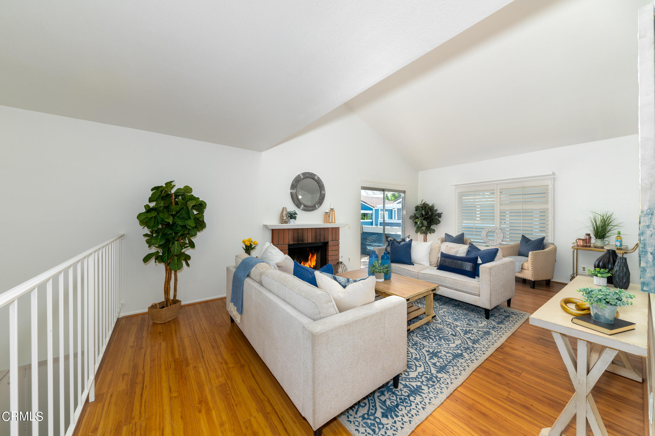 a living room with furniture and a potted plant