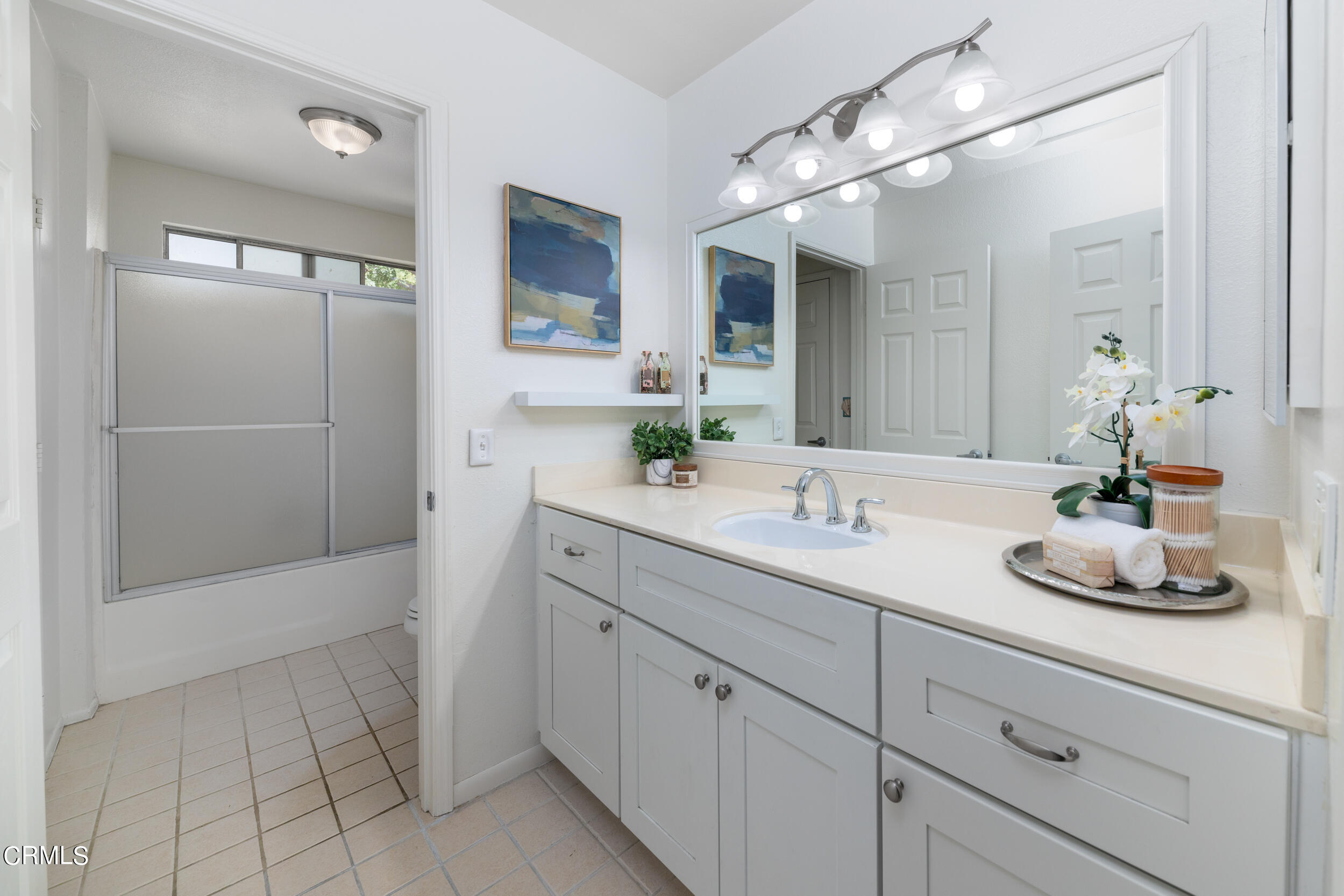 24100 Ave Rancheros, Unit G Diamond Bar, CA 91765 - Photo 16 of 20 a bathroom with a sink a large mirror and shower