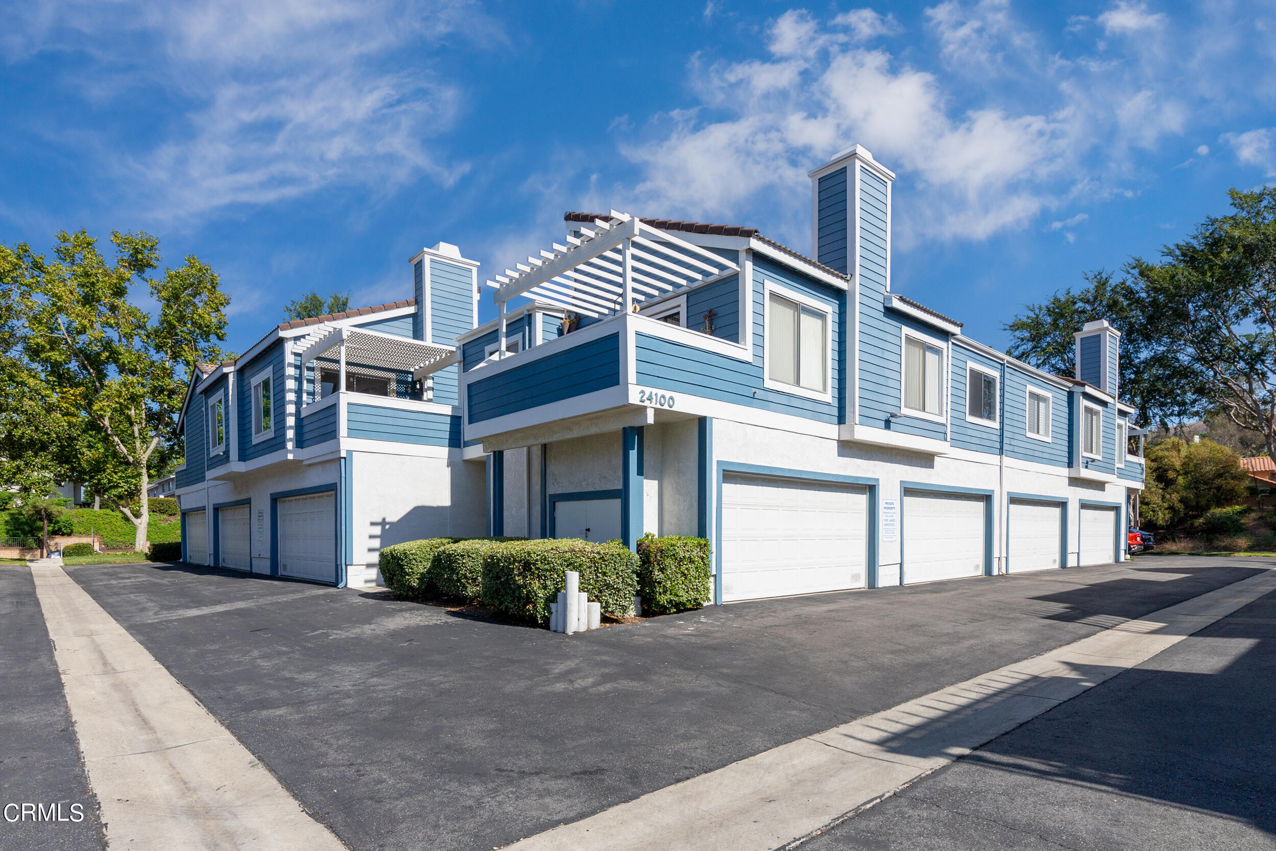 24100 Ave Rancheros, Unit G Diamond Bar, CA 91765 - Photo 2 of 20 a front view of a house with a yard and garage