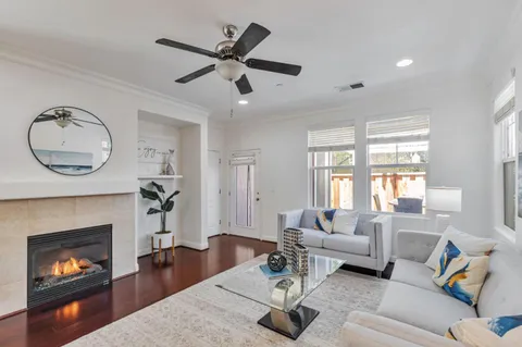 a living room with furniture a fireplace and a large window