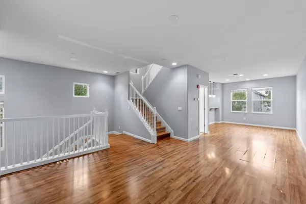 a kitchen with stainless steel appliances a dining table chairs and granite counter tops