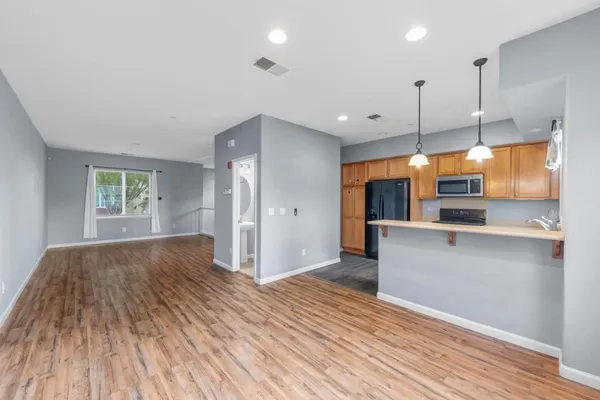 a kitchen with granite countertop cabinets and refrigerator