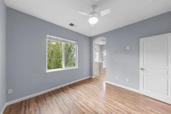 a bedroom with a bed and a painting on the wall