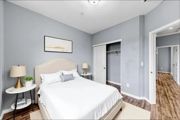 a view of an empty room with wooden floor