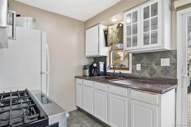 a kitchen with cabinets and stove